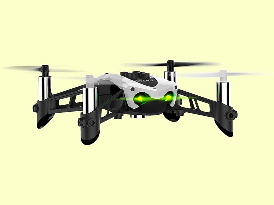 A white drone with glowing green lights for eyes in flight, with a yellow background.