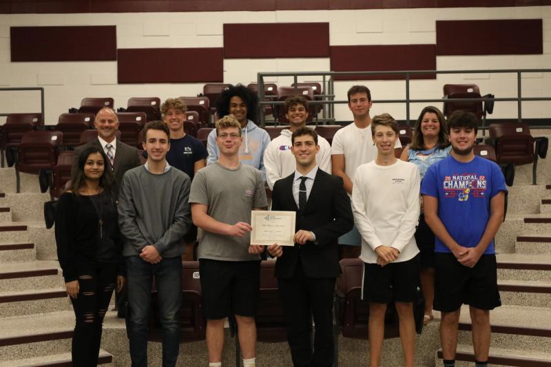 Principal Mr. Ken Costa and Business teacher Mrs. Steuber present their Junior Achievement Gold Award recipients from Whitman's National Business Honor Society.