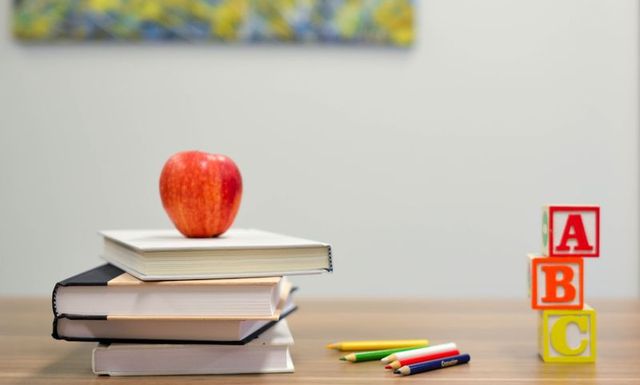 Desk with books and a red apple
