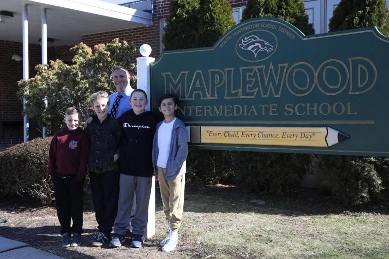 Fourth-graders AJ Demarest, Miroslav Lucey, Jonah Becker and Henry Thorn, with Principal Hender