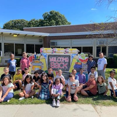 students in front of school in group photo