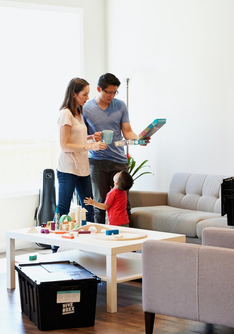 man, woman and child standing together in living rooms