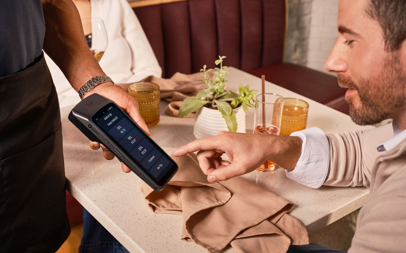 Cliente paga uma refeição com cartão de benefício em uma maquininha no caixa de um restaurante. — Foto: SpotOn POS (Pexels)