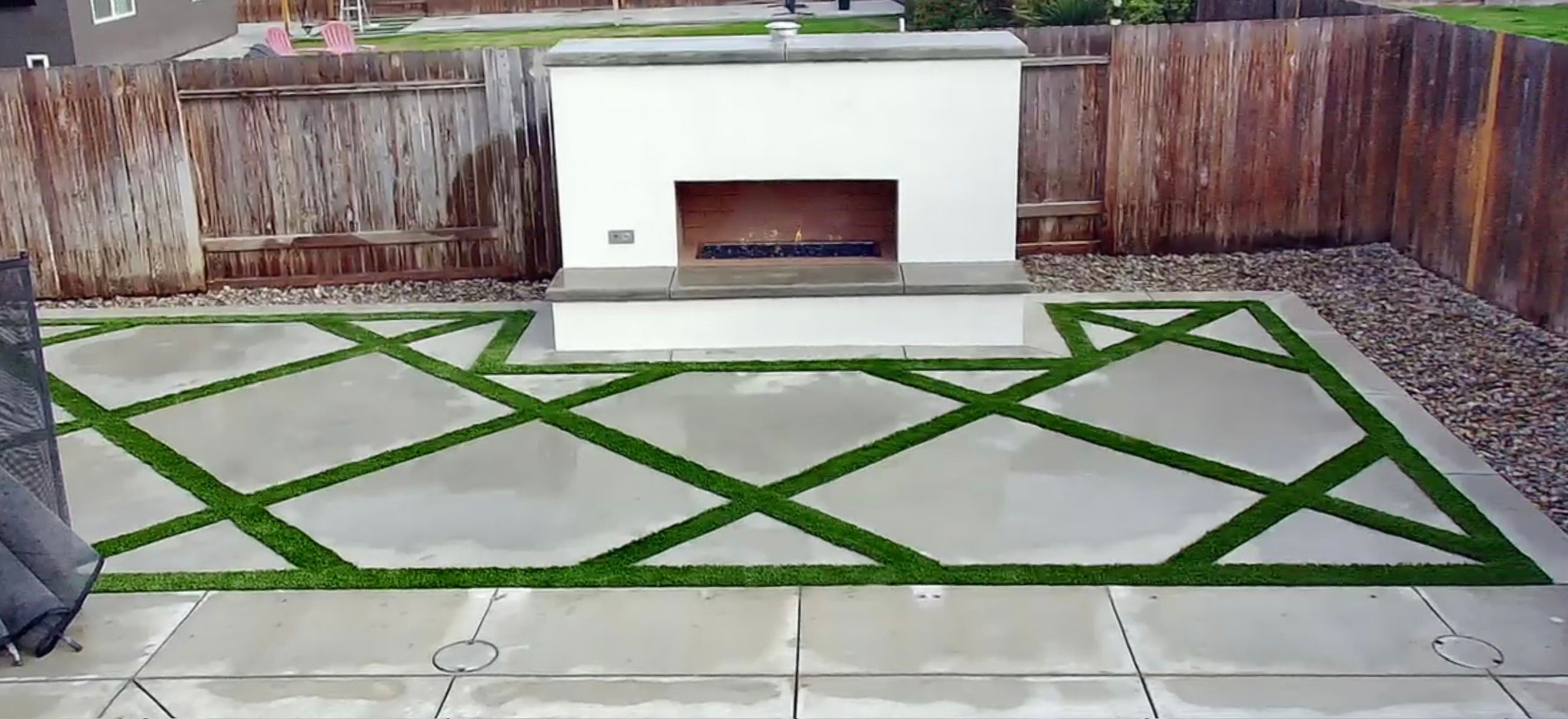 Modern outdoor fireplace with geometric turf pattern