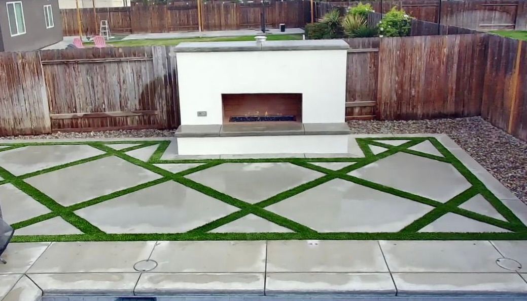 Modern outdoor fireplace with geometric turf pattern