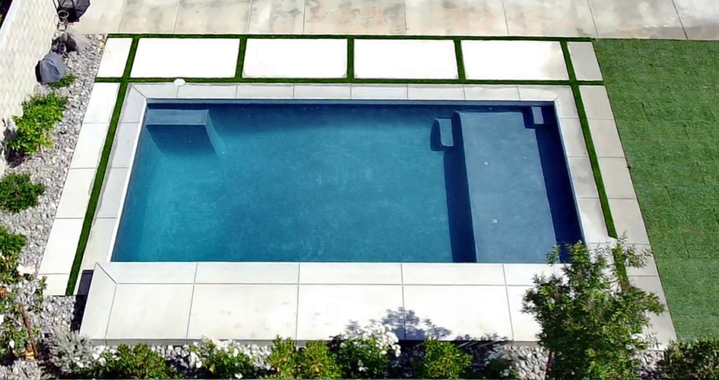 Stamped concrete pool deck with a textured stone pattern and clean edging around the pool.