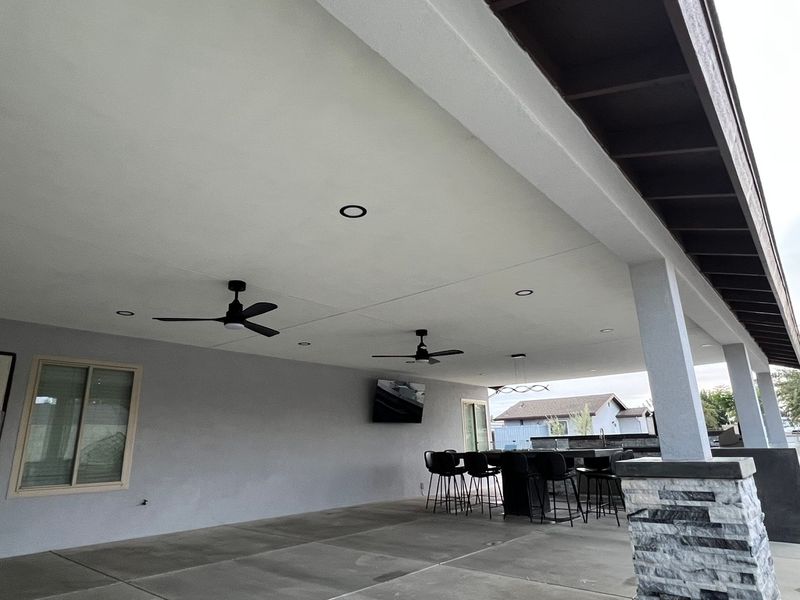 Large covered patio with fire pit table