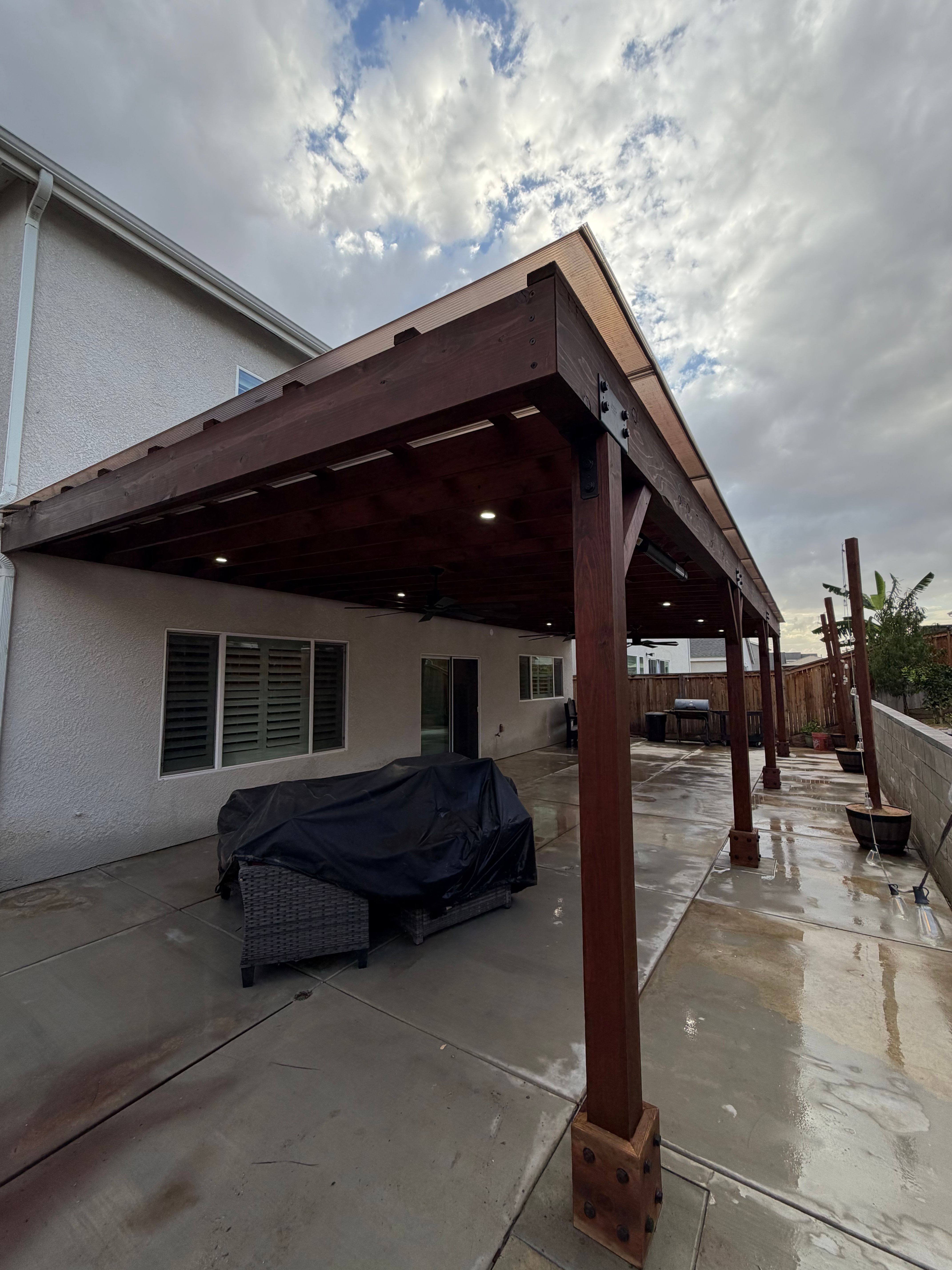 16’ x 40’ wood patio cover built with Redwood lumber and finished with Dark Walnut stain.