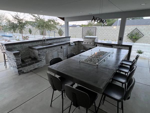 Premium outdoor kitchen with fire pit table and entertainment setup