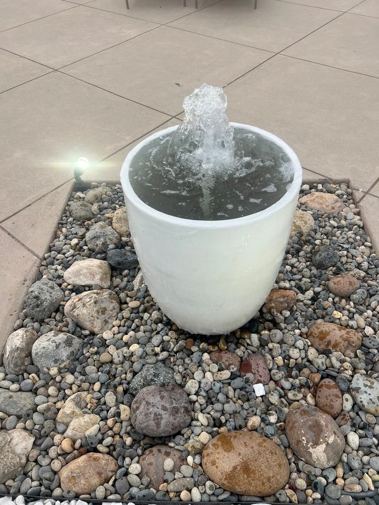 White pot fountain on concrete patio
