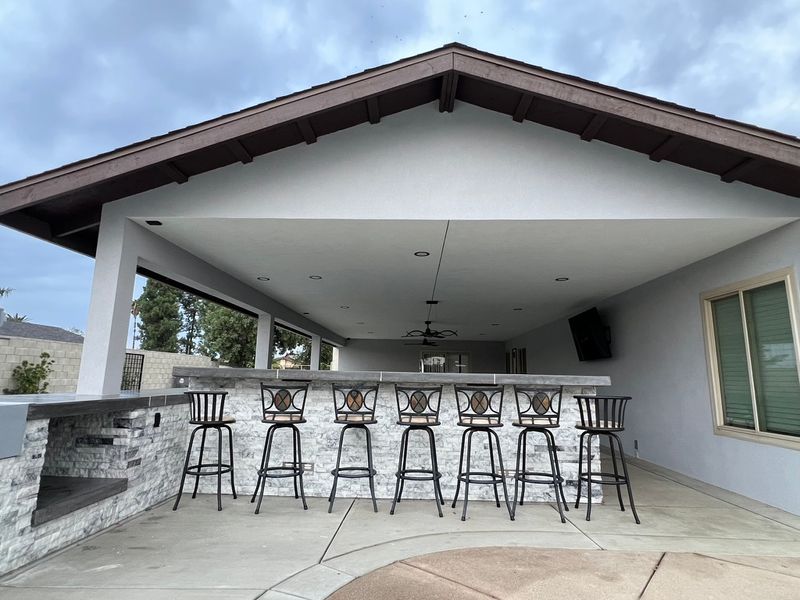 Large covered patio with stone bar and gabled roof
