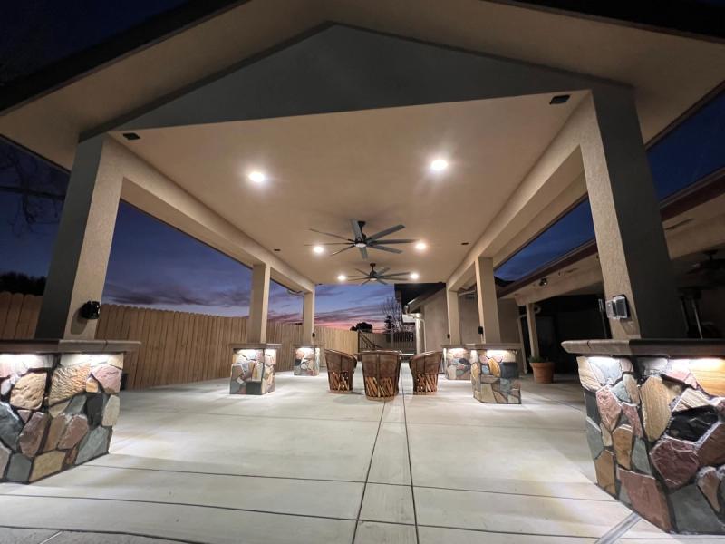 Stunning evening patio with stone columns and luxury seating