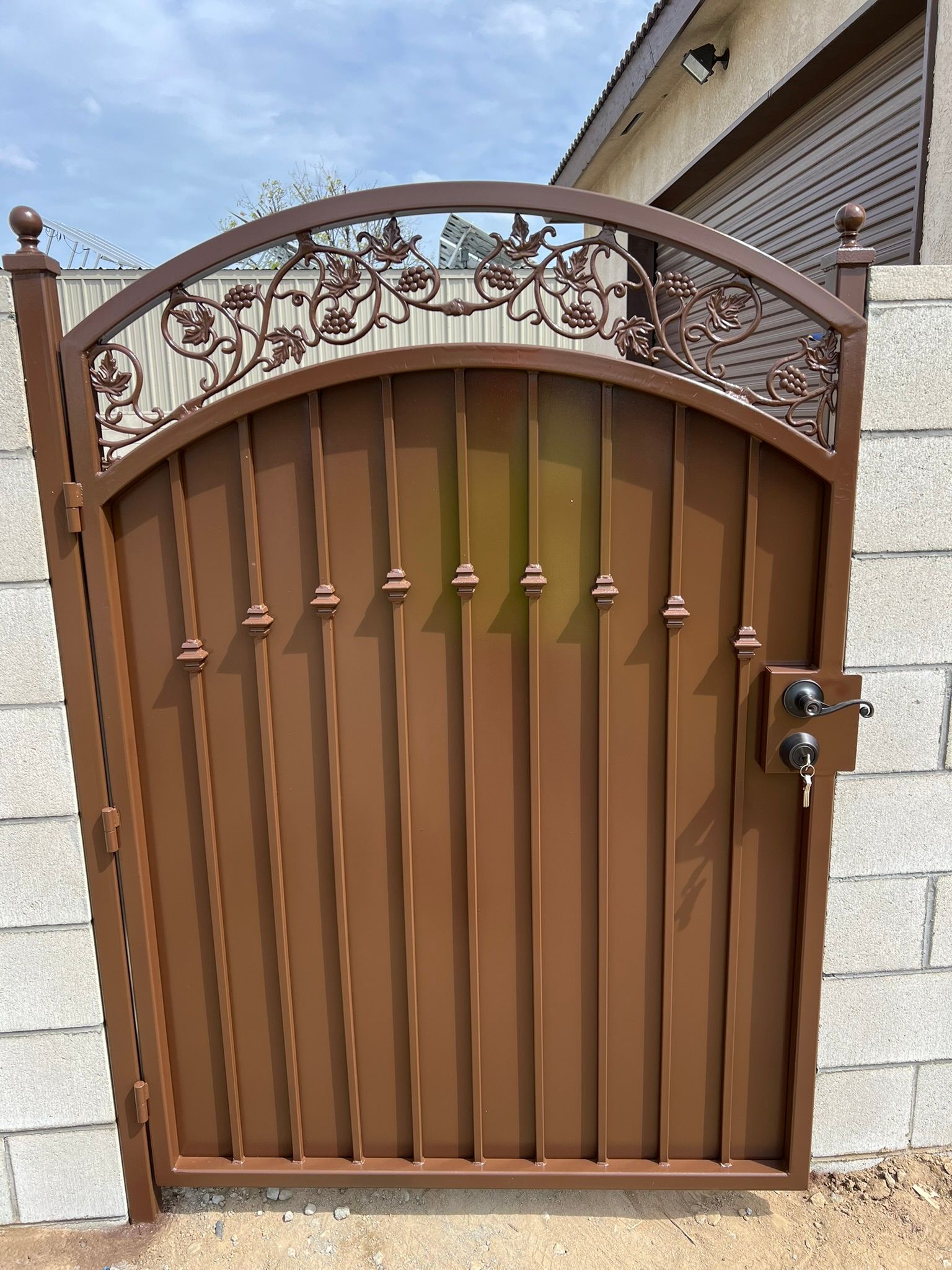 Decorative iron gate with grapevine scroll design