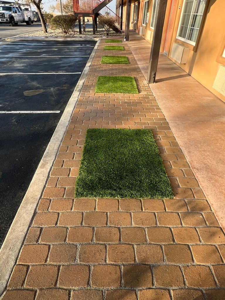 Commercial stamped brick sidewalk with turf insets