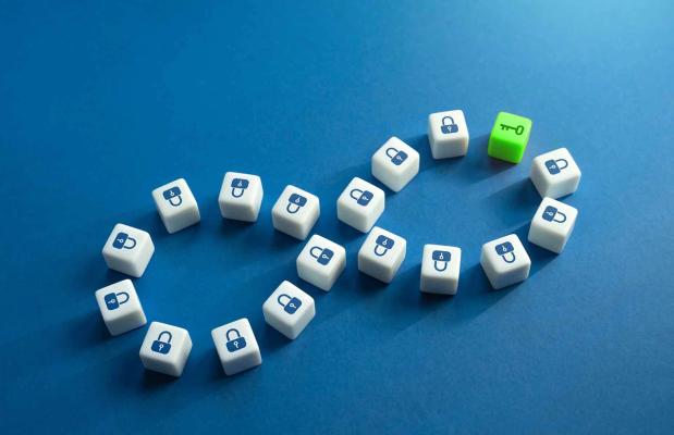 Padlock dice laid out in an infinity loop, with a single green key die