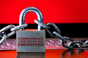 Computer has been blocked access to Data with Ransomware. Can not access Data by Malware, Encrypt and Hacking Conceptual with Padlock. The Old padlock and Chains On Laptop with Red Screen.
