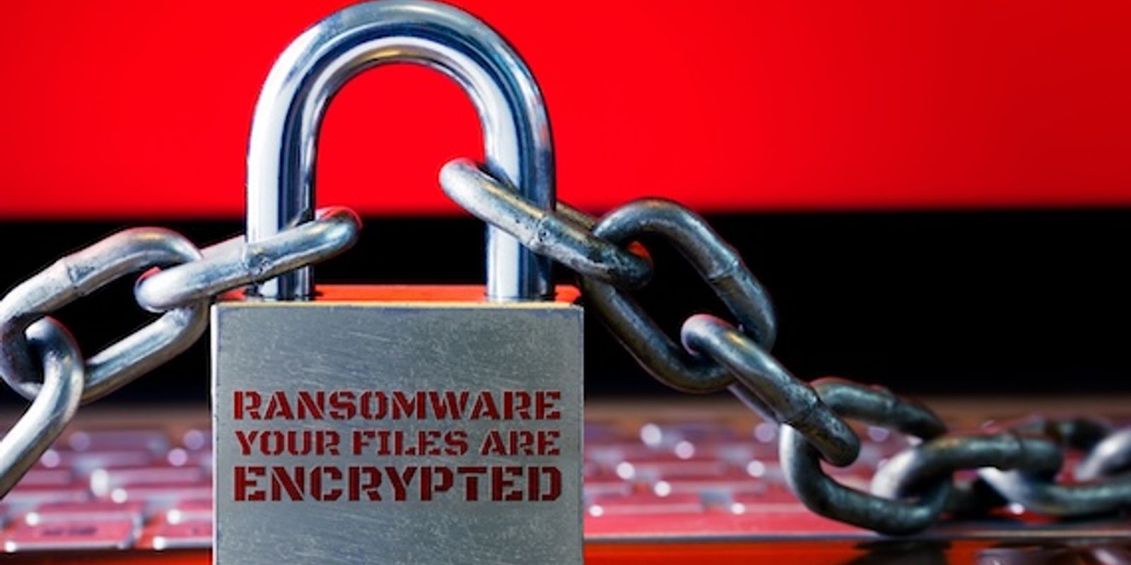 Computer has been blocked access to Data with Ransomware. Can not access Data by Malware, Encrypt and Hacking Conceptual with Padlock. The Old padlock and Chains On Laptop with Red Screen.