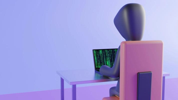 Illustration of a hooded figure at a laptop showing green code
