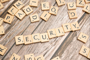 Scrabble tiles spelling the word security among scattered letters