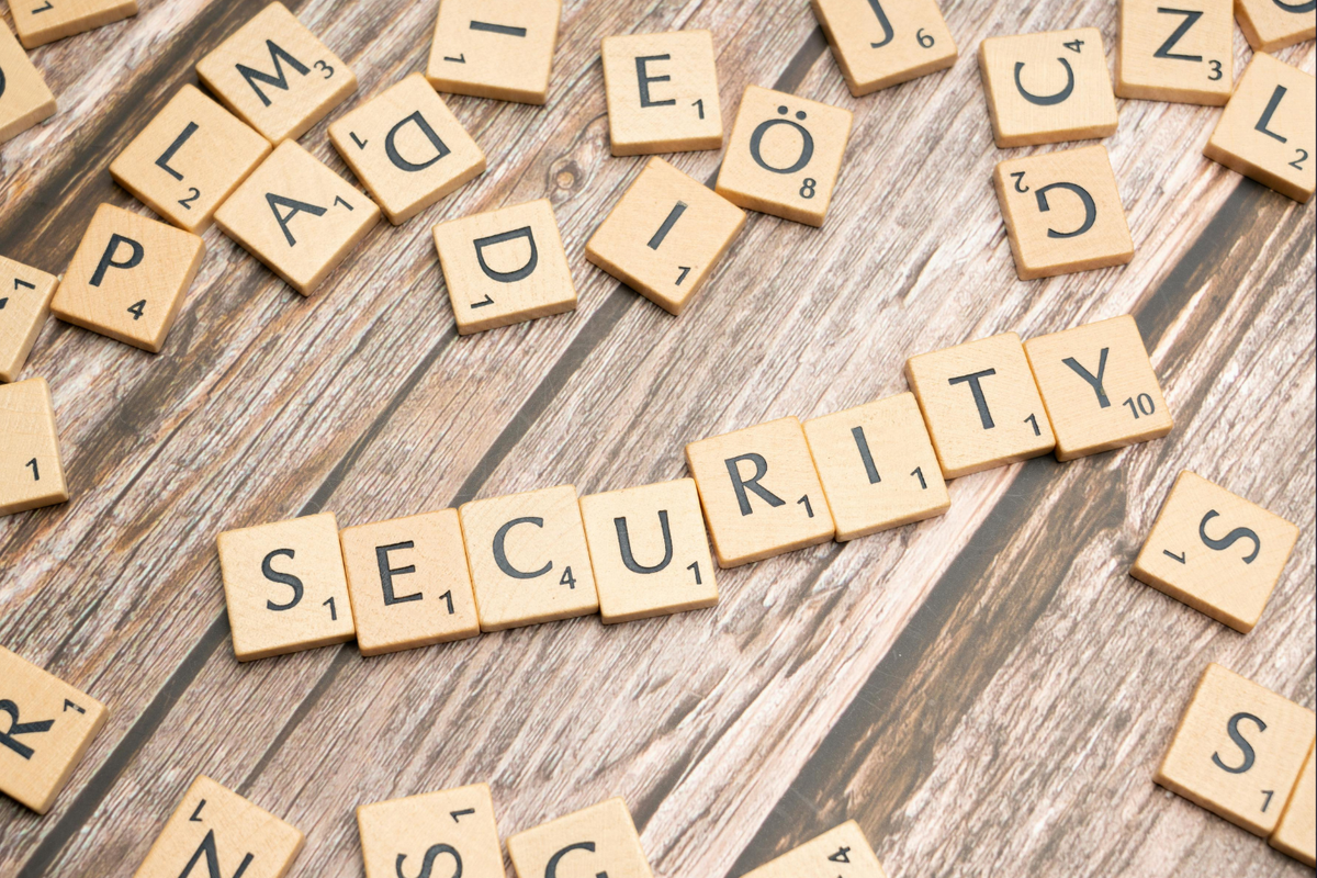 Scrabble tiles spelling the word security among scattered letters