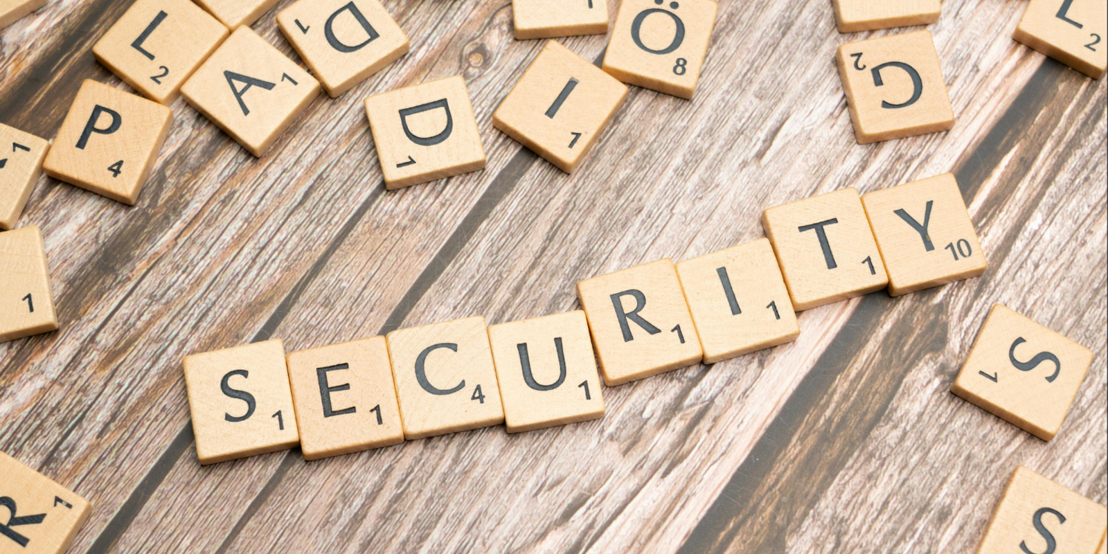 Scrabble tiles spelling the word security among scattered letters
