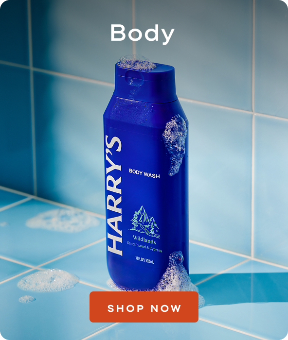 blue bottle of body wash against light blue tile background