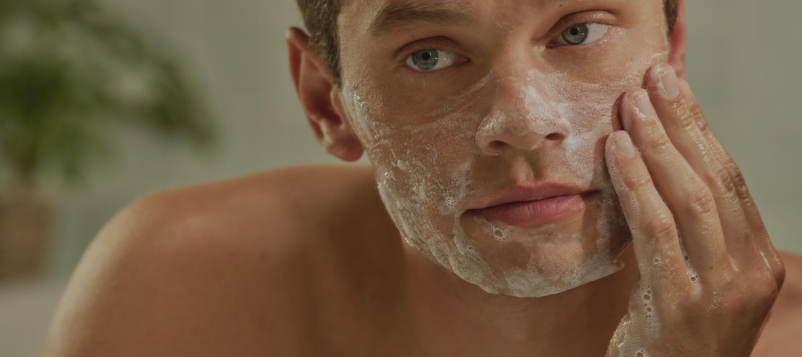 A man washing his face with Harry's face wash