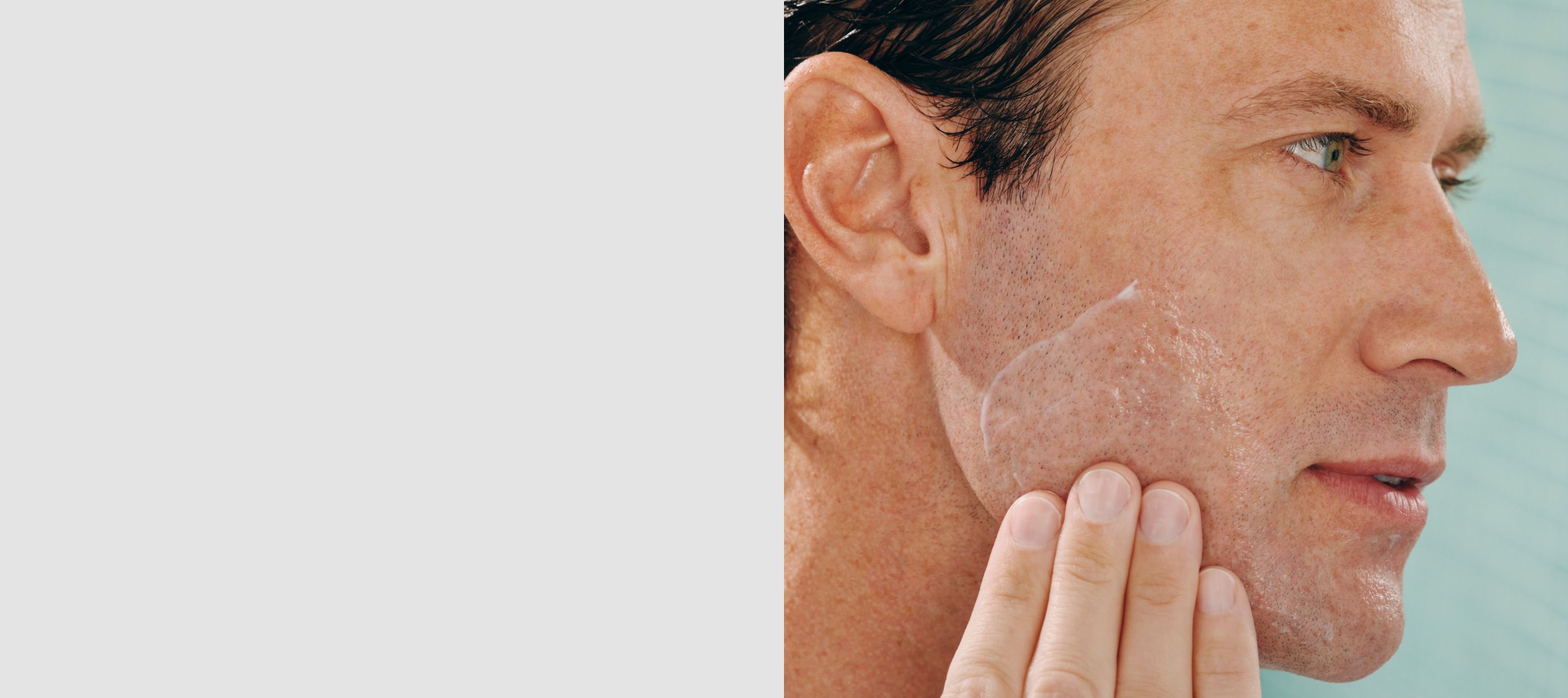Man applying lotion to his cheek