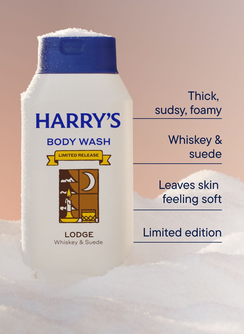An off white bottle of Lodge scent body wash in a bank of snow
