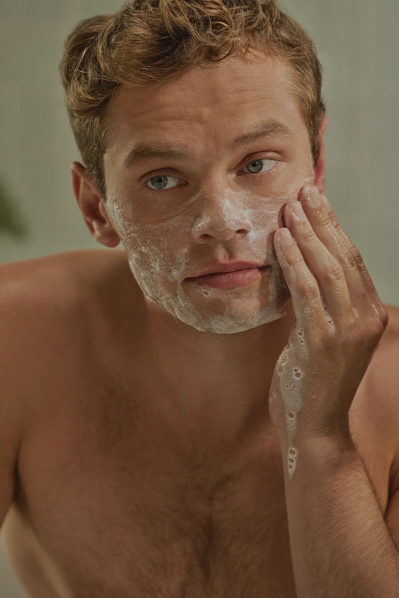 A man washing his face with Harry's face wash