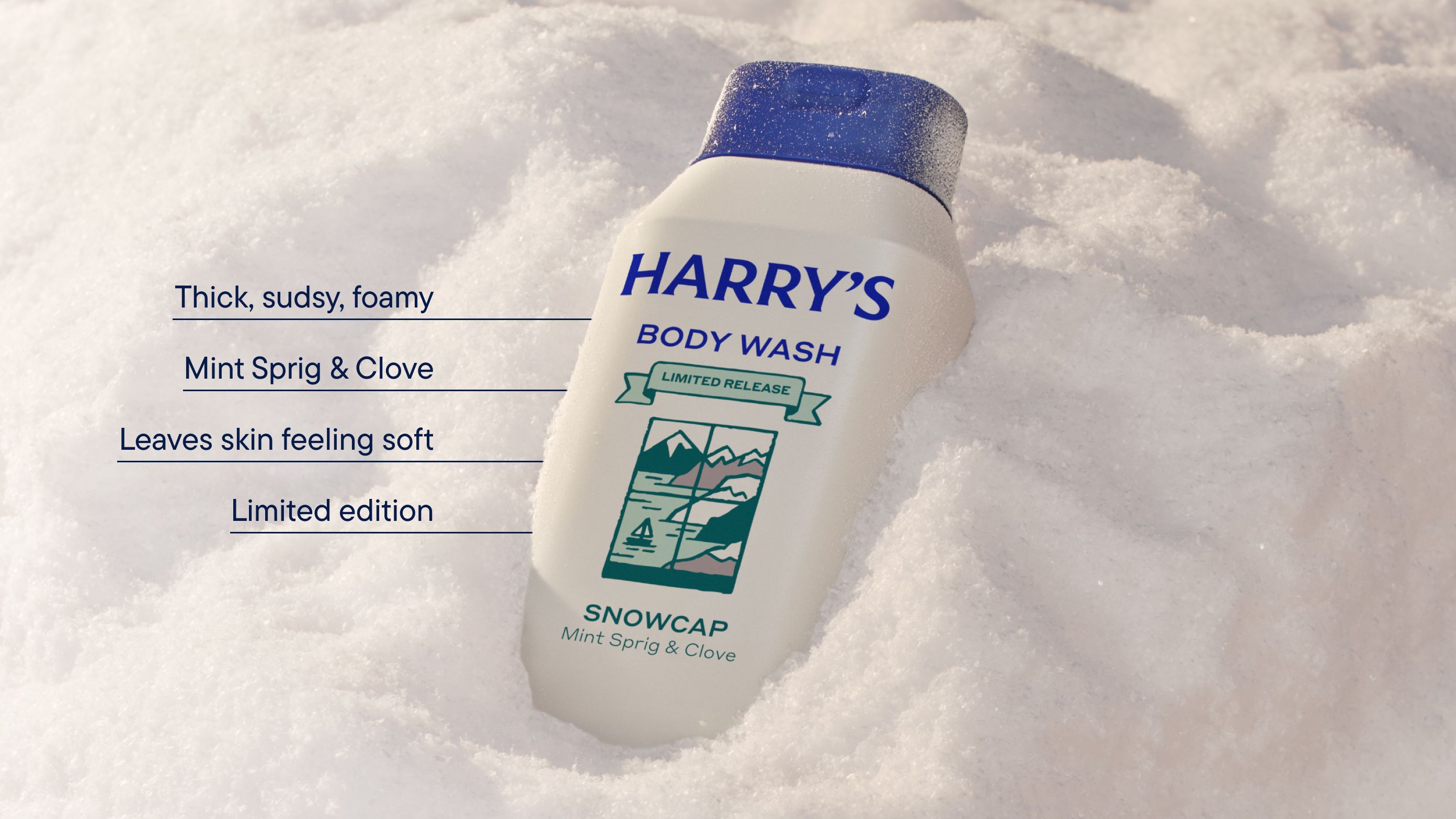 An off white bottle of Snowcap scent body wash in a bank of snow