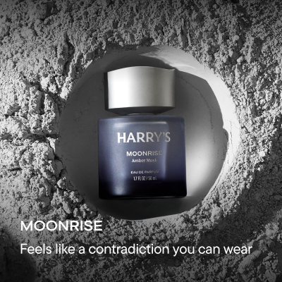 Bottle on powdered background. Text reads, Moonrise feels like a contradiction you can wear