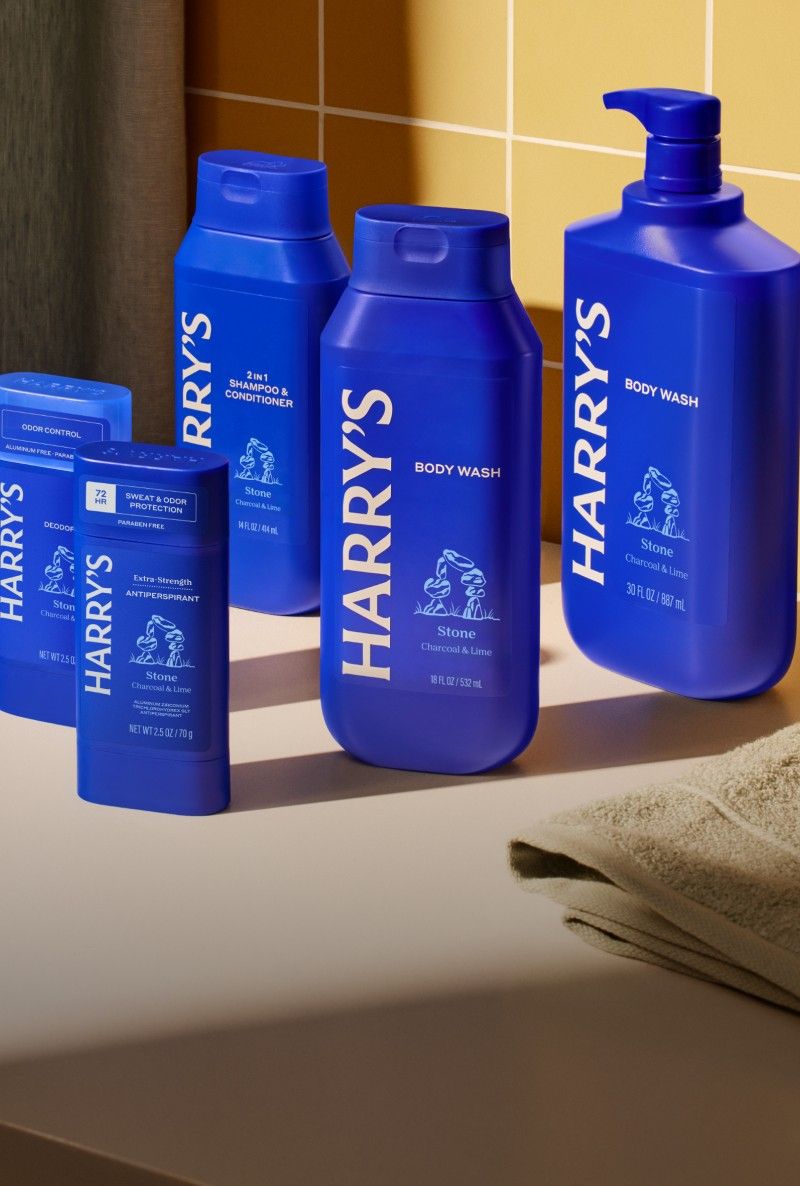 Set of blue bottles with 'Harry's' branding on a bathroom counter.