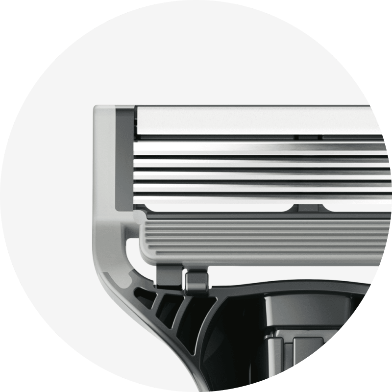 Close-up of white lubrication strip on razor cartridge.