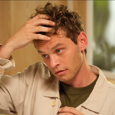 Man rubbing weightless volumizing hair cream into hair.