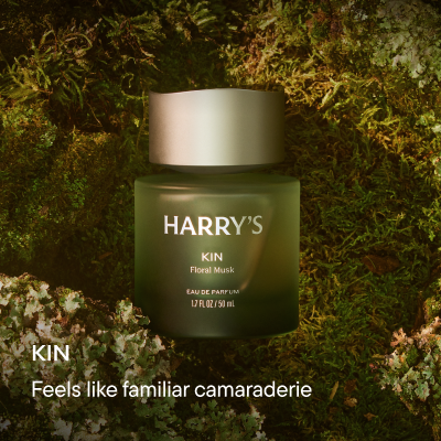 Green bottle on mossy background. Text reads: Kin, Feels like familiar camaraderie