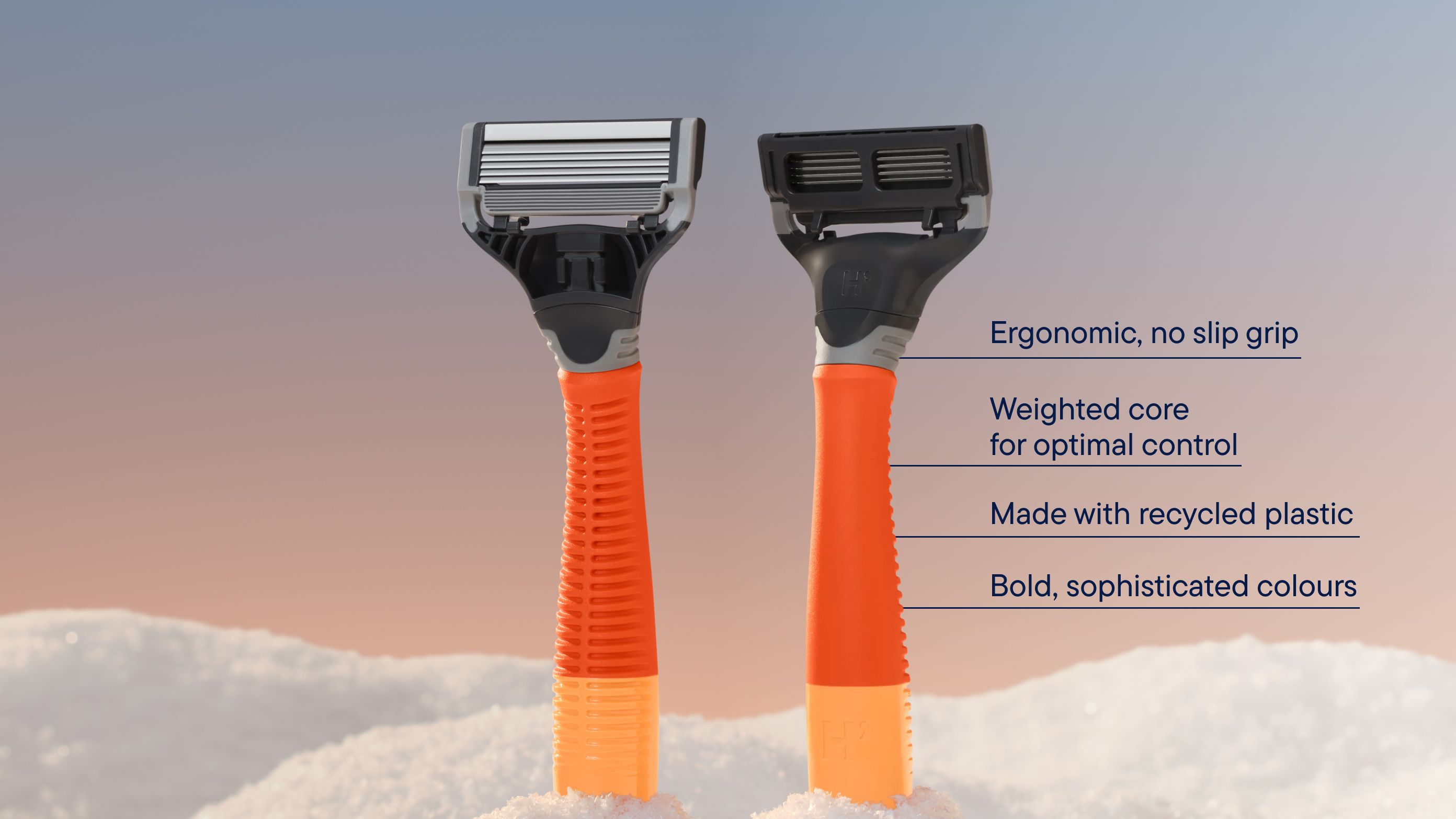 An orange handled razor in a bank of snow
