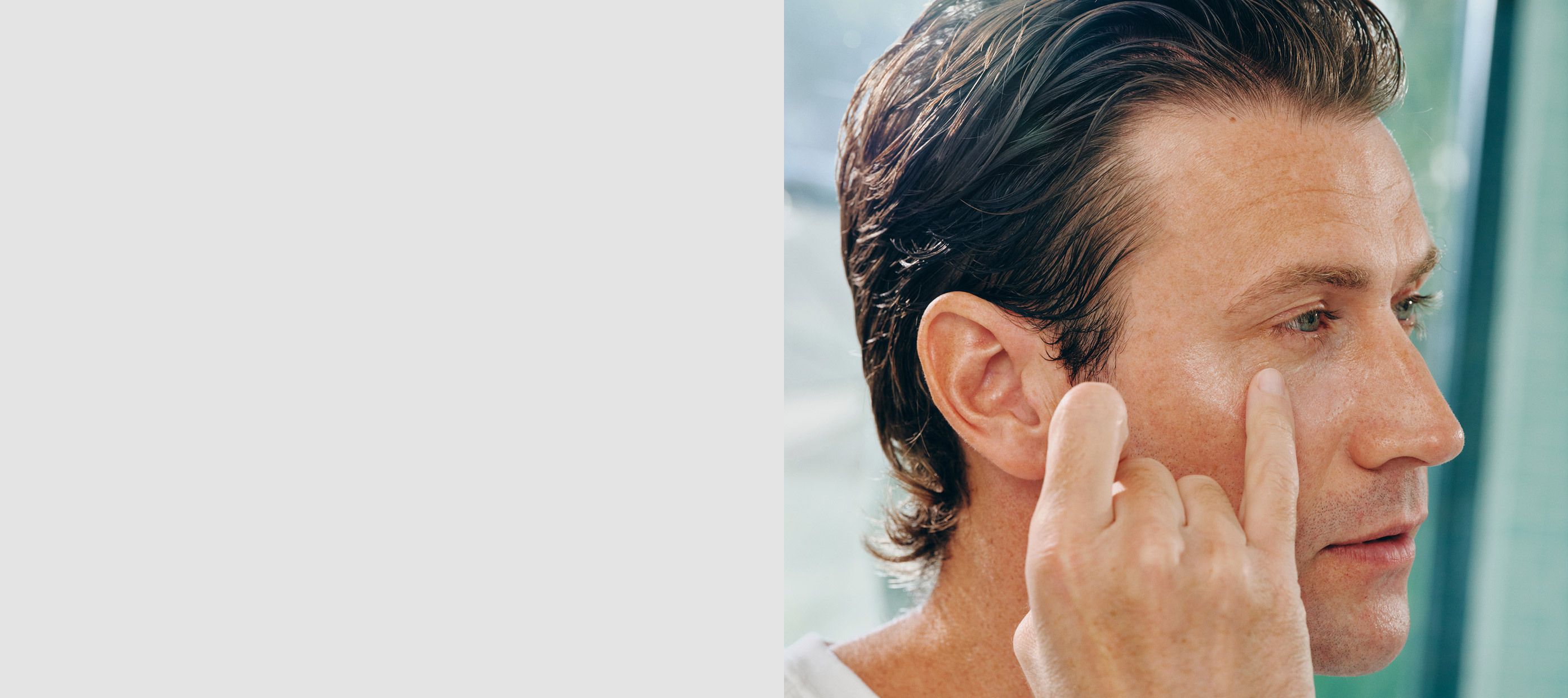Man applying product to the under-eye area using his pinky