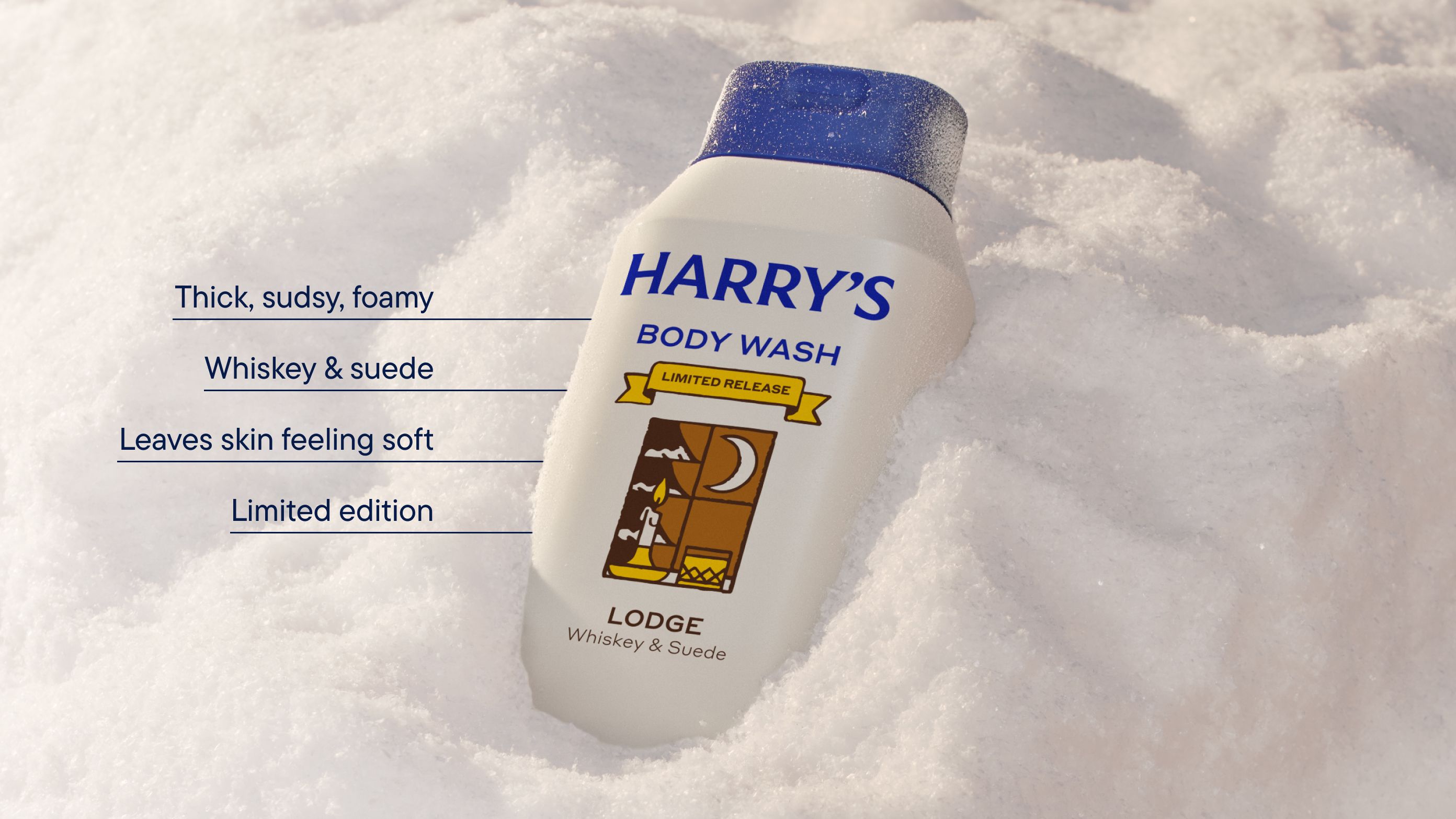 An off white bottle of Lodge scent body wash in a bank of snow