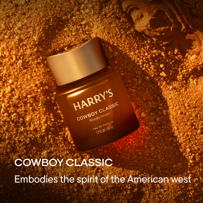 Bottle on sandy background. Text reads, Cowboy Classic, embodies the spirit of the American West.