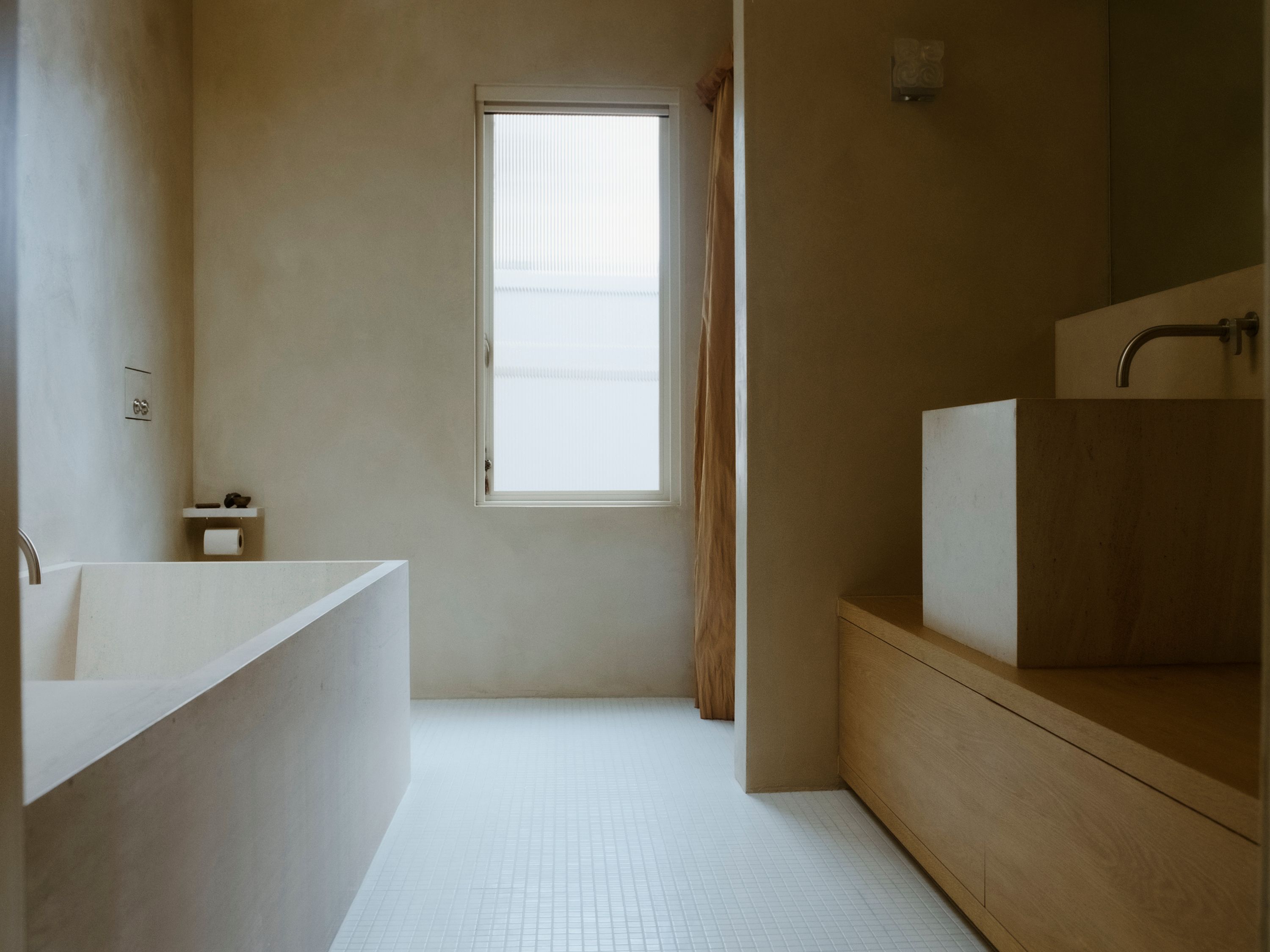 a room with white tile floor, stone bath tub, and wooden cabinets, with a tall vertical window, WOE, Width Over Ears