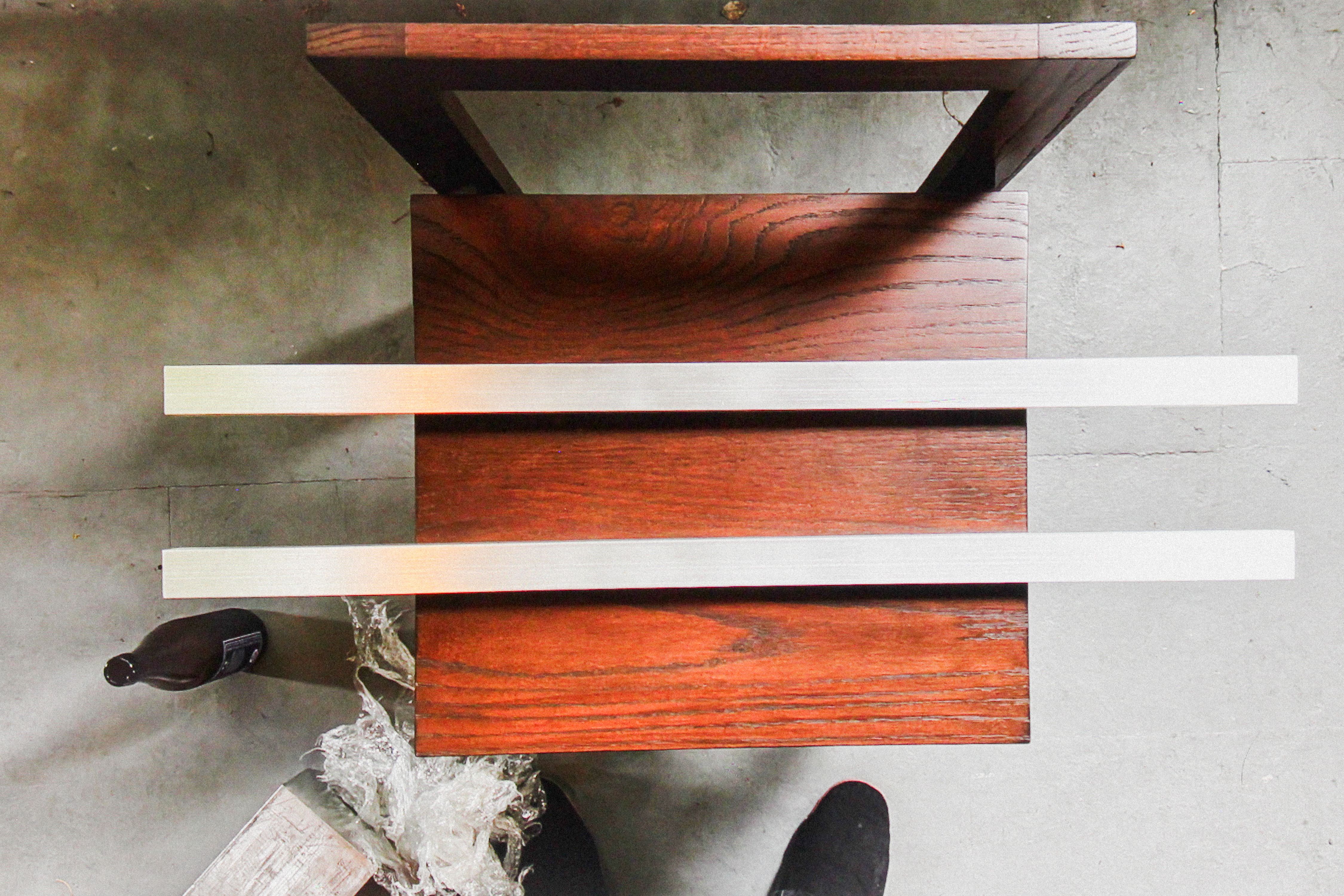 two long aluminum bars on a wooden chair, WOE, Width Over Ears