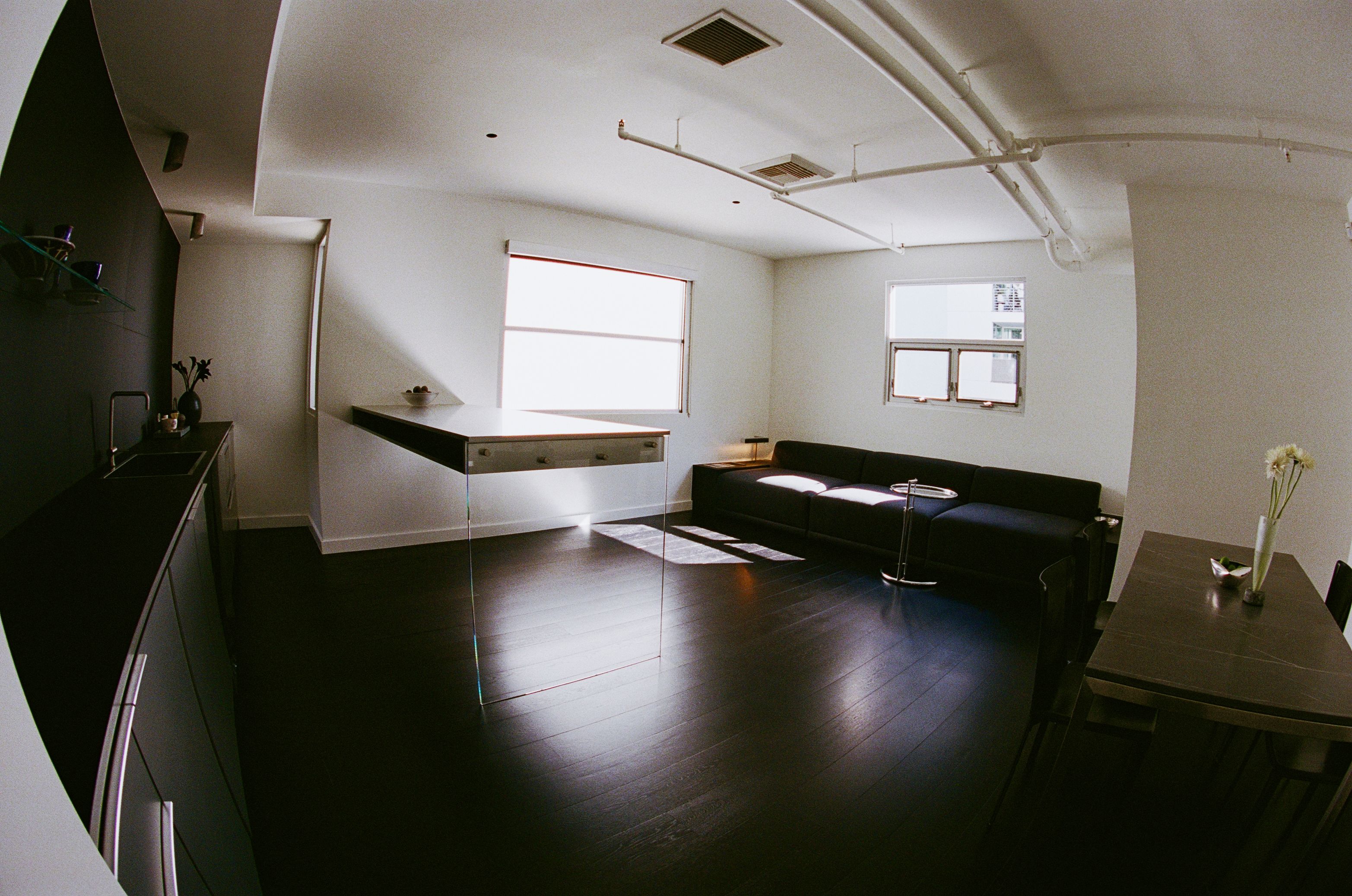 a kitchen counter, island, sofa and table