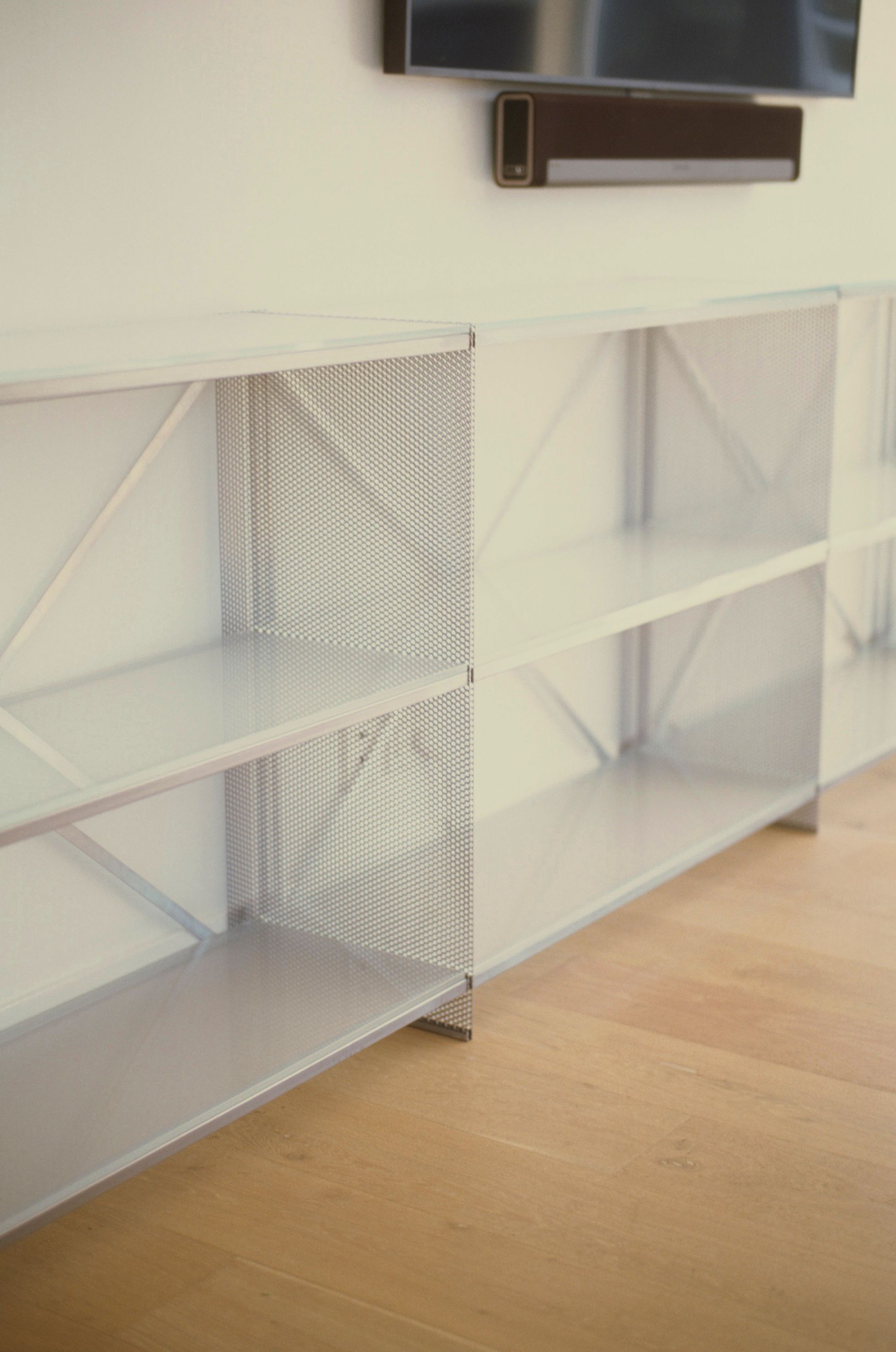 metal and glass shelving on wooden flooring