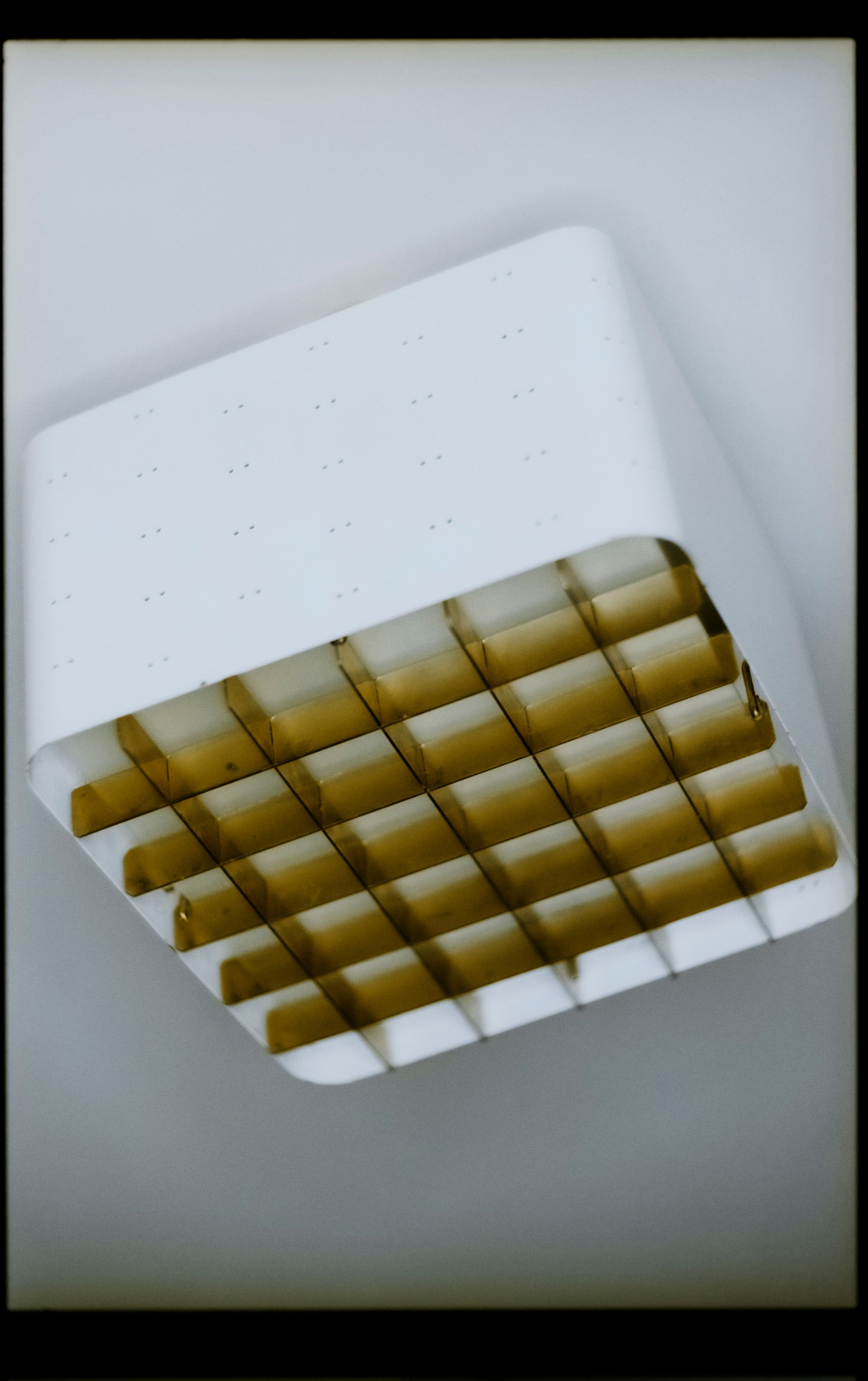 a close up image of a gold and cream ceiling light fixture, Paavo Tynell, WOE, Width Over Ears