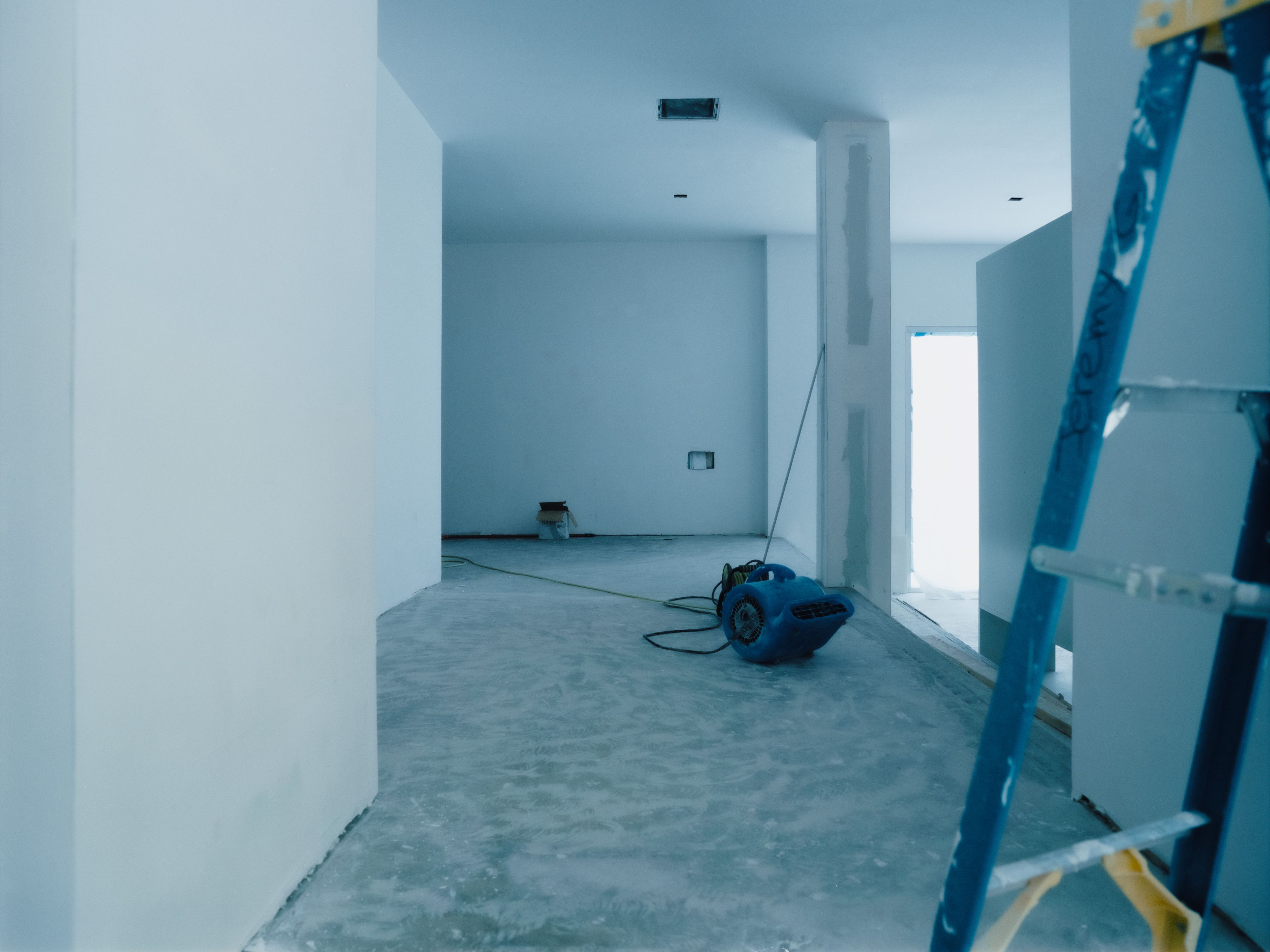 a large room with a blue hue and niches with shelves, WOE, Width Over Ears