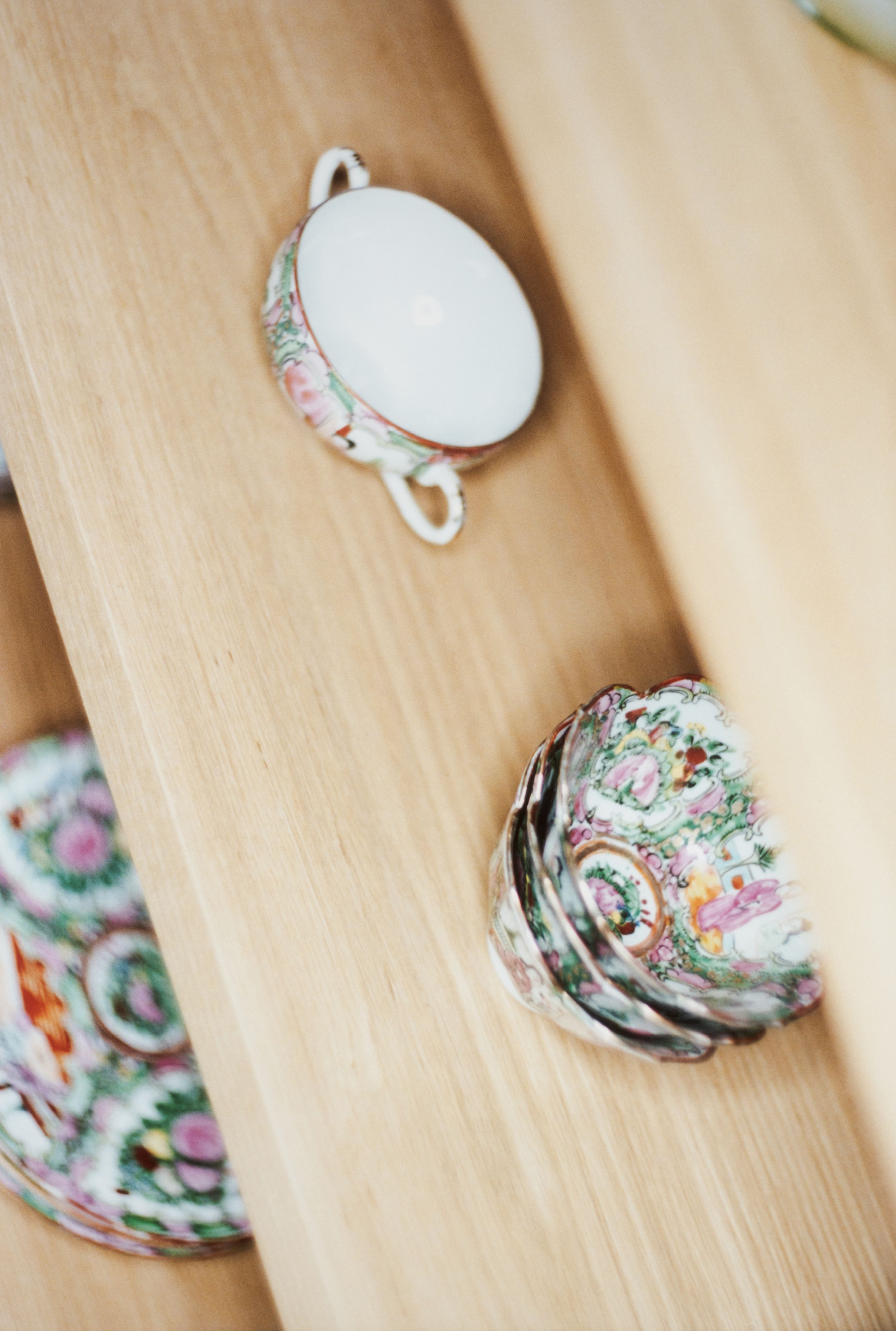 a Chinese tea set on wooden shelves