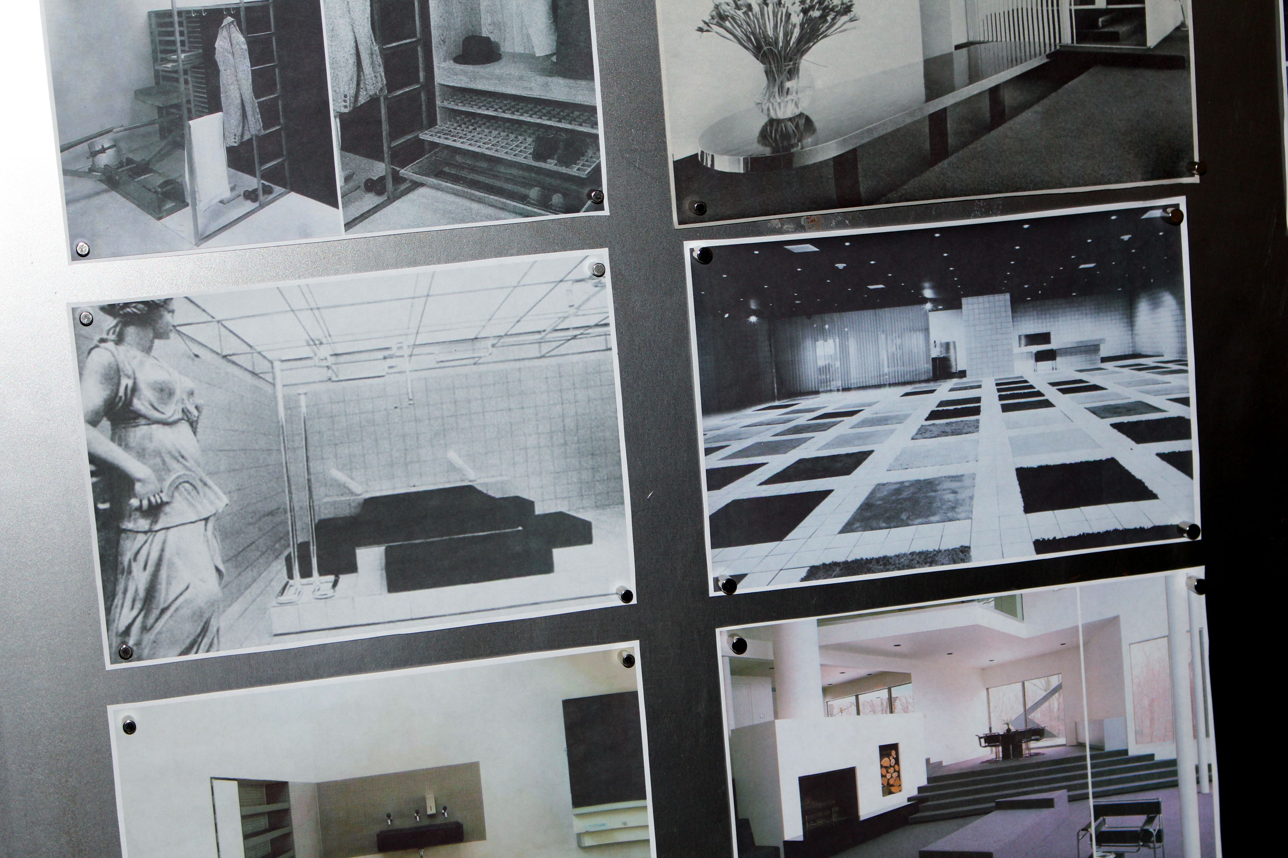 a metal wall with various images pinned to it, WOE, Width Over Ears