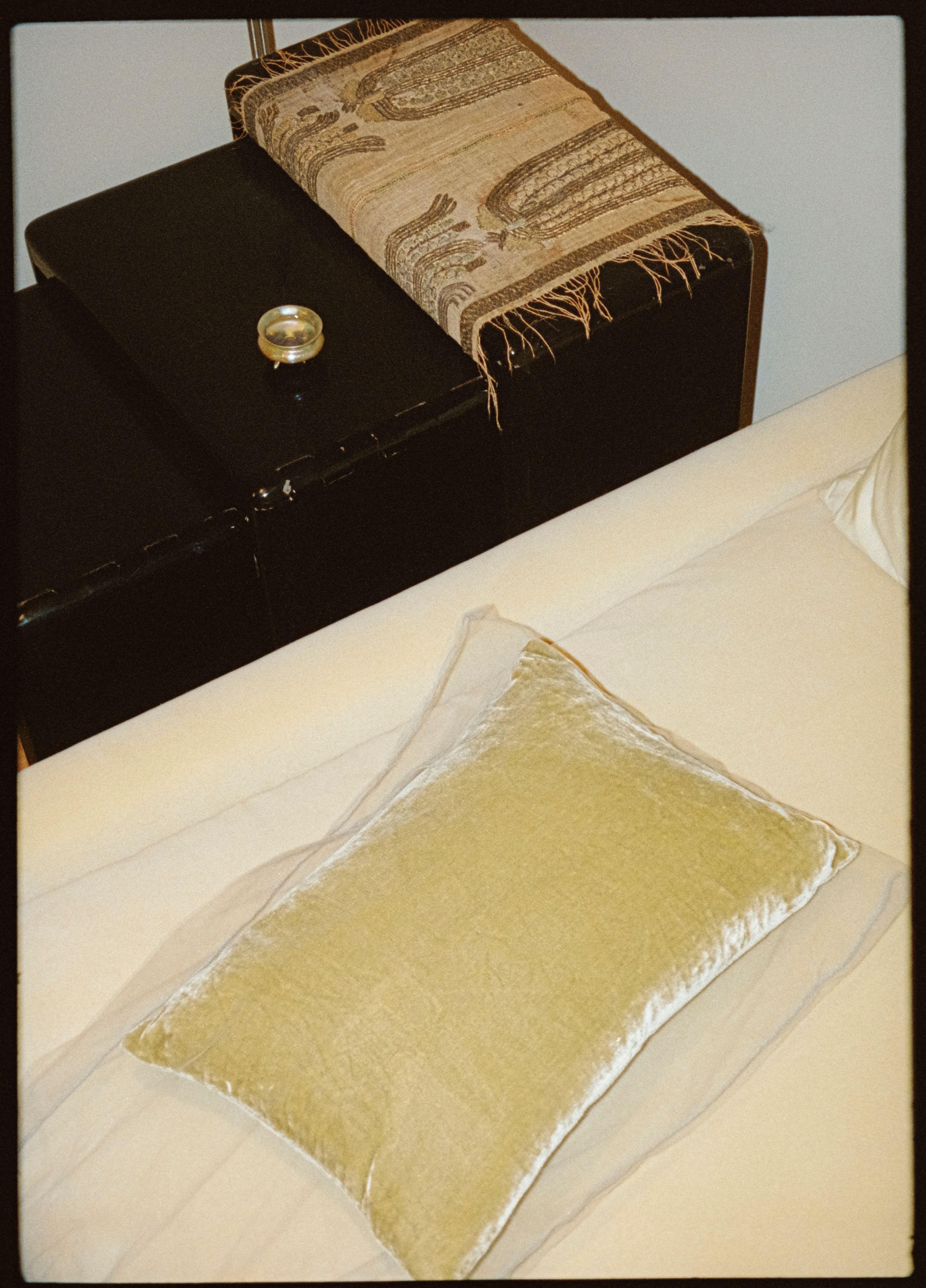 yellow pillow on a yellow sofa with black side tables, WOE, width over ears, interior design