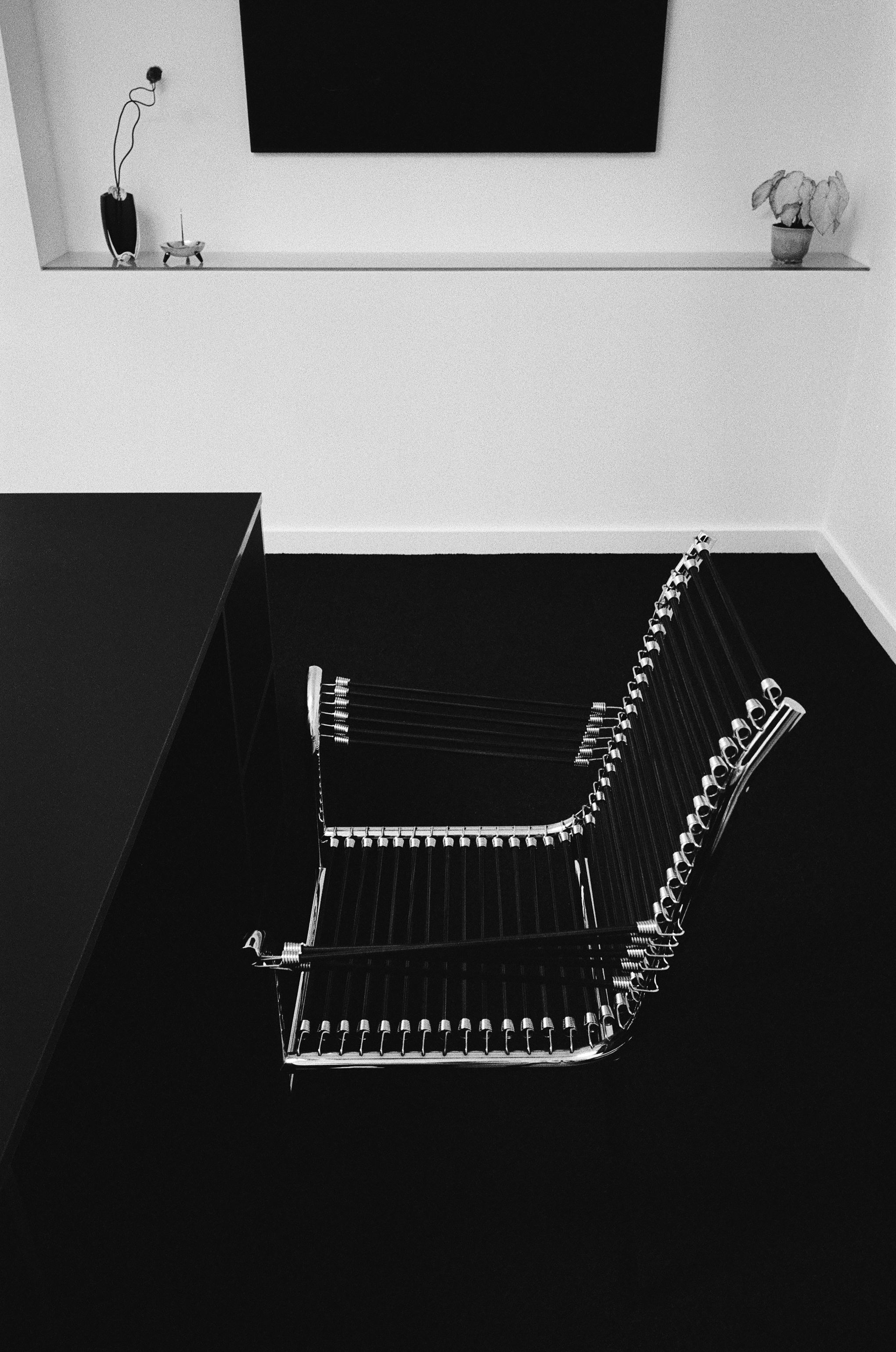 a black and white image of a chair made from bungee chords